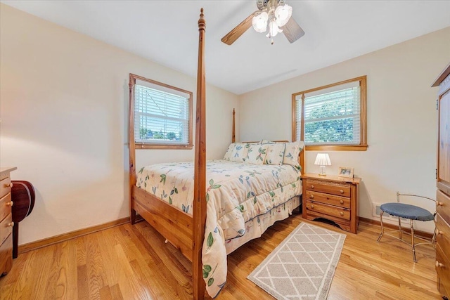 bedroom with light wood-type flooring, baseboards, and a ceiling fan