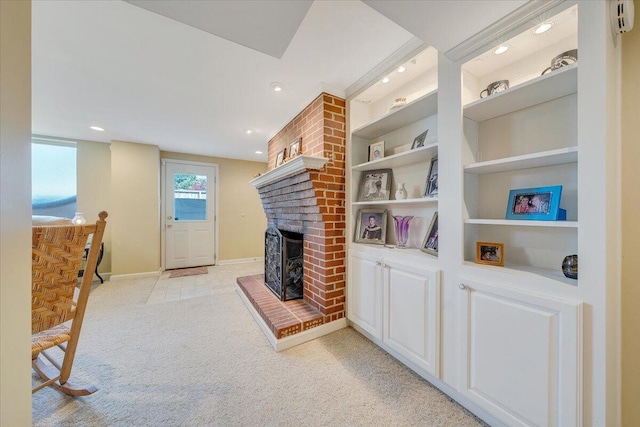 living area featuring light colored carpet, a fireplace, recessed lighting, baseboards, and built in features