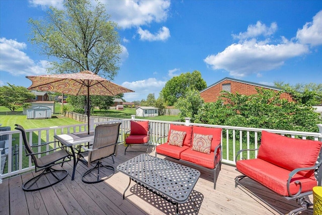 wooden deck featuring outdoor dining area and a lawn