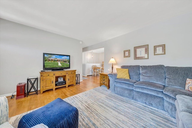 living area featuring light wood finished floors and baseboards