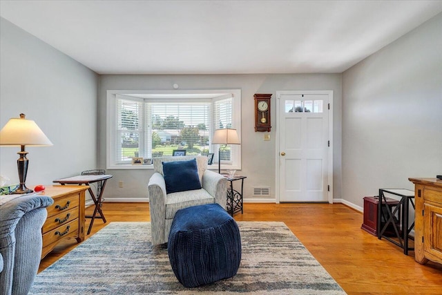 sitting room with light wood-style flooring and baseboards