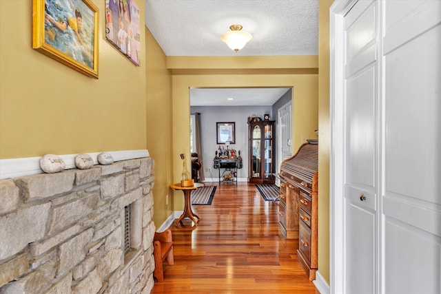 145 W Arrowhead Ct, Troutville, VA 24175 - corridor featuring wood finished floors, a textured ceiling, and baseboards