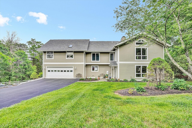 145 W Arrowhead Ct, Troutville, VA 24175 - view of front of home featuring asphalt driveway, a garage, a chimney, a front yard, and a shingled roof