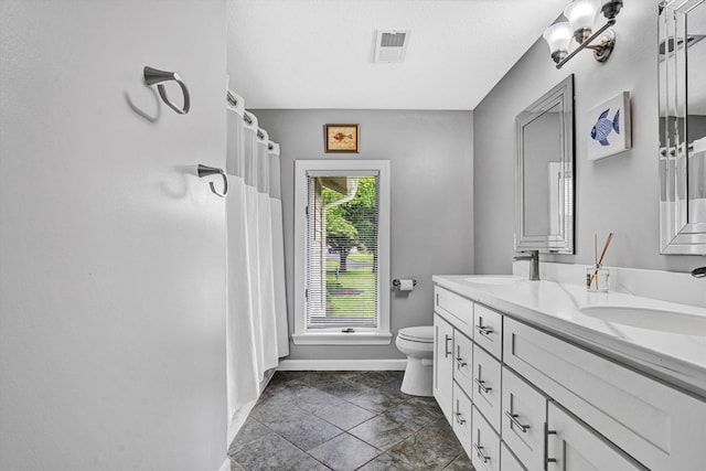 145 W Arrowhead Ct, Troutville, VA 24175 - bathroom with baseboards, double vanity, toilet, and curtained shower