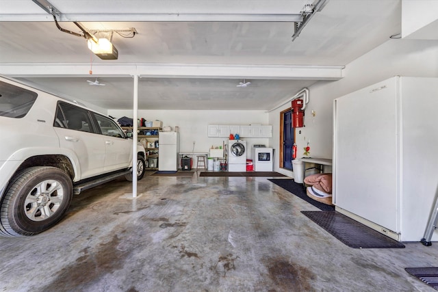 145 W Arrowhead Ct, Troutville, VA 24175 - garage featuring freestanding refrigerator, washing machine and dryer, a central vacuum unit, and a garage door opener