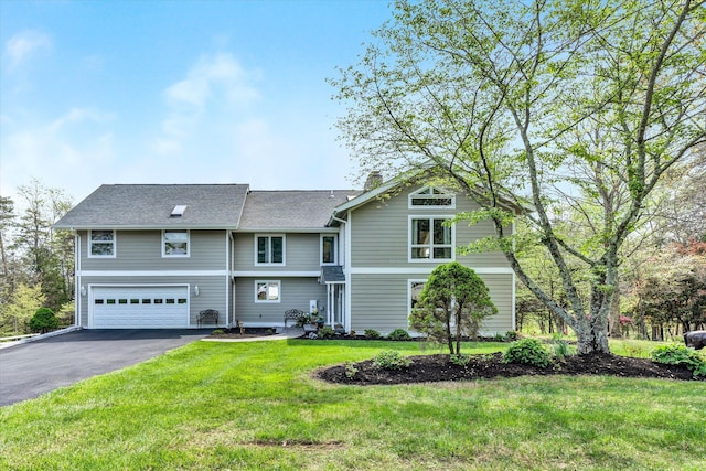 145 W Arrowhead Ct, Troutville, VA 24175 - view of front of home with an attached garage, asphalt driveway, a chimney, and a front lawn