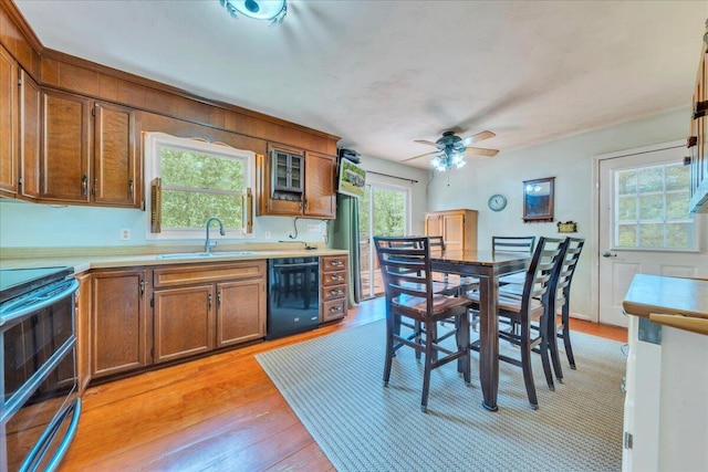 1793 Sandy Level Rd, Goodview, VA 24095 - kitchen featuring a sink, dishwasher, double oven range, light wood-type flooring, and brown cabinets
