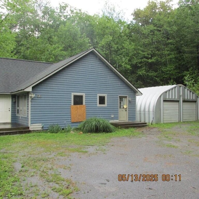 56 Craig Woods Rd, New Castle, VA 24127 - view of home's exterior featuring an outbuilding, a detached garage, and a shingled roof