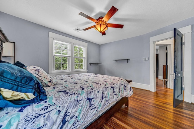 2102 Berkley Ave SW, Roanoke, VA 24015 - bedroom with wood finished floors, baseboards, ceiling fan, and a textured ceiling