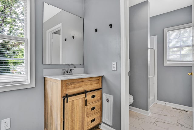 1228 Thomas Ave NW, Roanoke, VA 24017 - bathroom with marble look tile flooring, vanity, toilet, and plenty of natural light