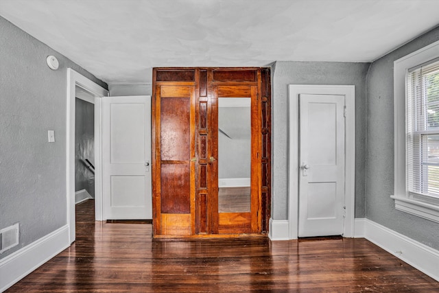 1228 Thomas Ave NW, Roanoke, VA 24017 - unfurnished bedroom with a textured wall, wood finished floors, and baseboards