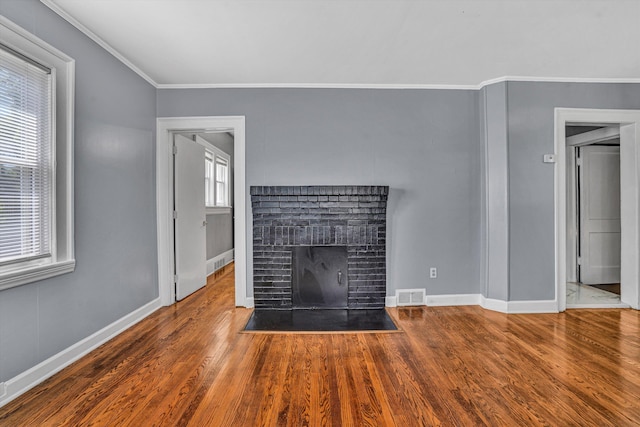 1228 Thomas Ave NW, Roanoke, VA 24017 - unfurnished living room featuring a brick fireplace, wood finished floors, crown molding, and baseboards