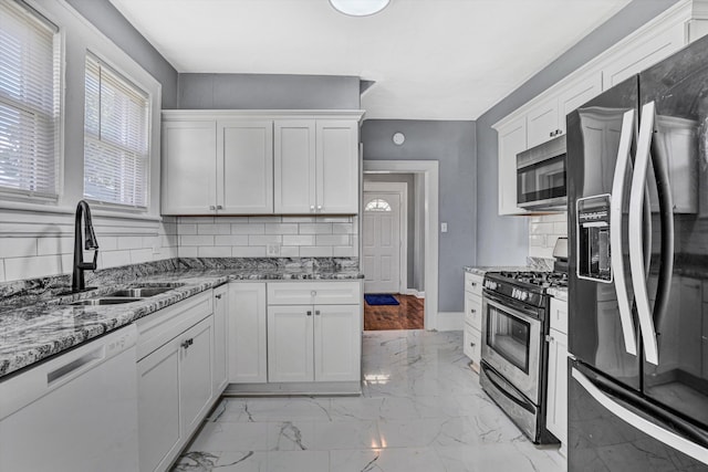 1228 Thomas Ave NW, Roanoke, VA 24017 - kitchen with appliances with stainless steel finishes, a sink, decorative backsplash, and light marble finish floors