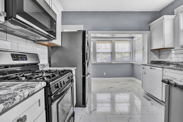 1228 Thomas Ave NW, Roanoke, VA 24017 - kitchen featuring stainless steel appliances, light marble finish flooring, tasteful backsplash, baseboards, and light stone counters