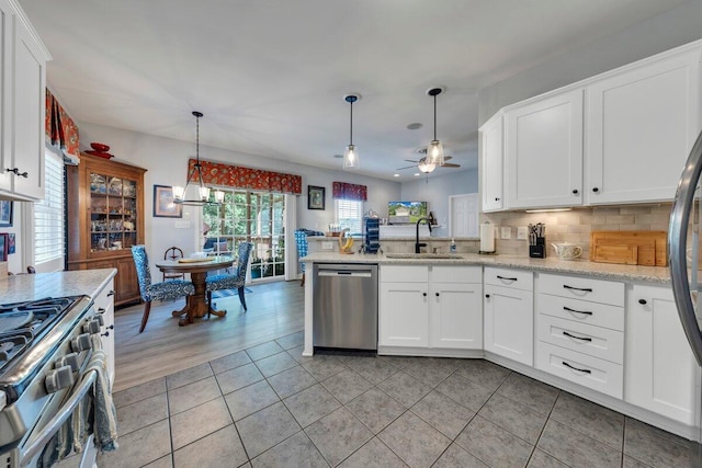 1017 Joffrey Dr, Huddleston, VA 24104 - kitchen with appliances with stainless steel finishes, a sink, a ceiling fan, a peninsula, and white cabinets
