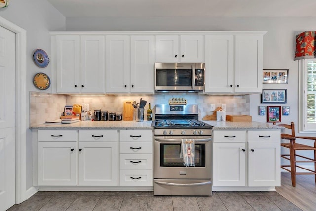 1017 Joffrey Dr, Huddleston, VA 24104 - kitchen featuring stainless steel appliances, white cabinets, backsplash, and light stone counters