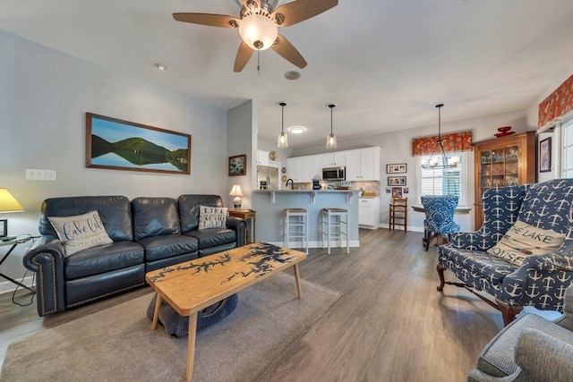 1017 Joffrey Dr, Huddleston, VA 24104 - living room featuring dark wood-style flooring, a ceiling fan, and baseboards