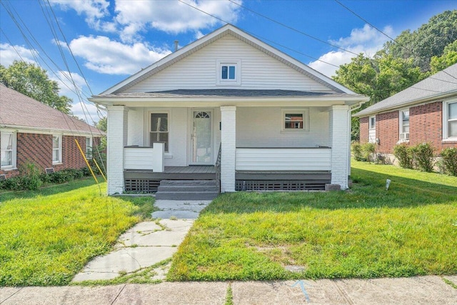 1008 Primrose St SE, Roanoke, VA 24014 - view of front of house featuring brick siding, a porch, and a front yard