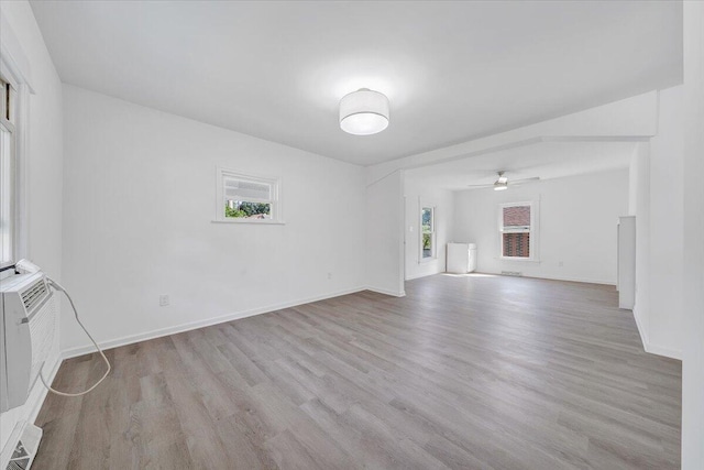 1008 Primrose St SE, Roanoke, VA 24014 - unfurnished living room with wood finished floors and ceiling fan