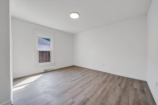 1008 Primrose St SE, Roanoke, VA 24014 - empty room with wood finished floors and baseboards
