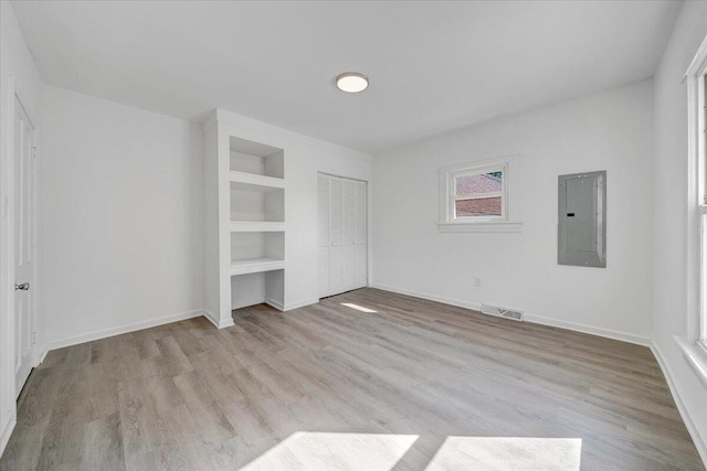 1008 Primrose St SE, Roanoke, VA 24014 - unfurnished bedroom with electric panel, wood finished floors, and a closet