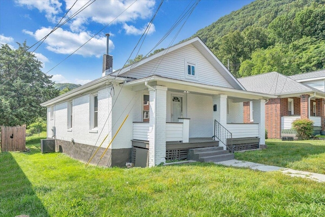 1008 Primrose St SE, Roanoke, VA 24014 - bungalow with a chimney, brick siding, covered porch, and a front yard