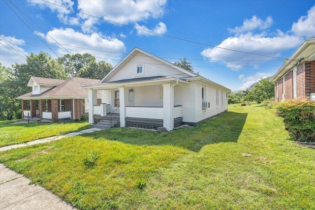 1008 Primrose St SE, Roanoke, VA 24014 - bungalow featuring covered porch, brick siding, a front lawn, and cooling unit