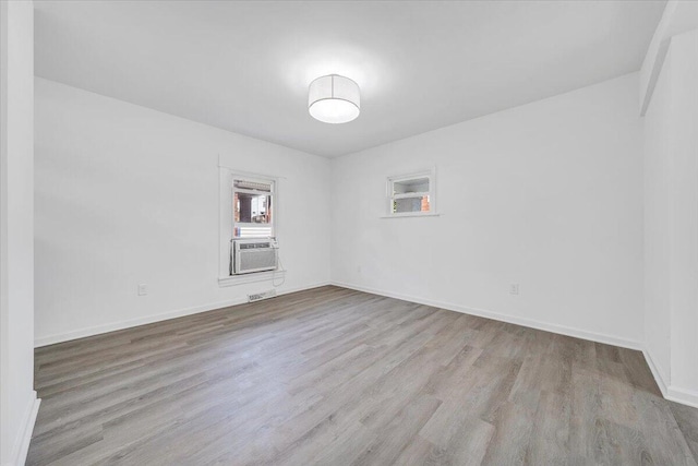 1008 Primrose St SE, Roanoke, VA 24014 - empty room with wood finished floors and cooling unit