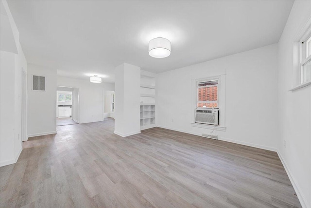 1008 Primrose St SE, Roanoke, VA 24014 - unfurnished living room featuring cooling unit and light wood-style floors