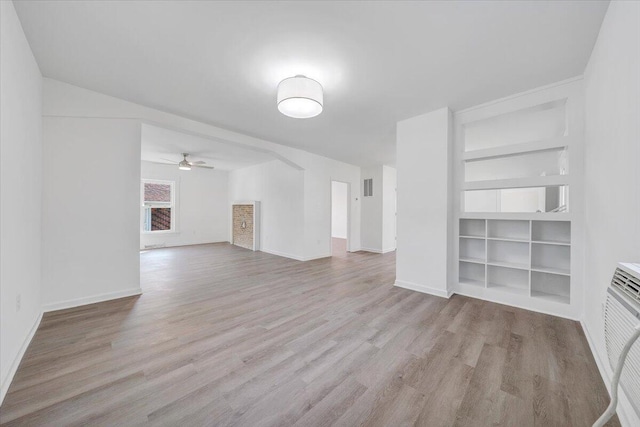 1008 Primrose St SE, Roanoke, VA 24014 - unfurnished living room with built in features, wood finished floors, and ceiling fan