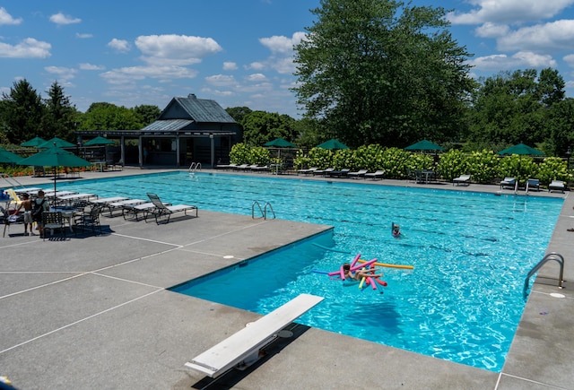 95 Shoreline Cir, Penhook, VA 24137 - community pool with a diving board, a patio area, and view of scattered trees