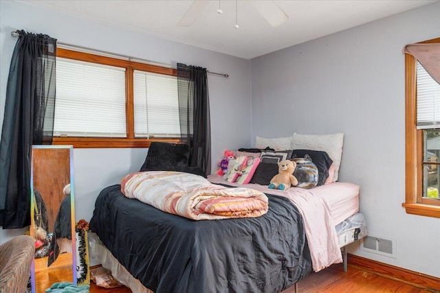 1829 Court St NW, Roanoke, VA 24012 - bedroom featuring multiple windows, wood finished floors, baseboards, and a ceiling fan