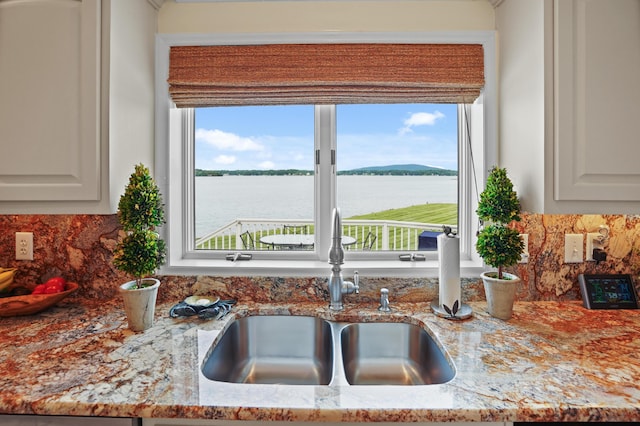 392 Carrs Point Ln, Moneta, VA 24121 - kitchen view of a sink, tasteful backsplash, light stone countertops, and a nearby body of water