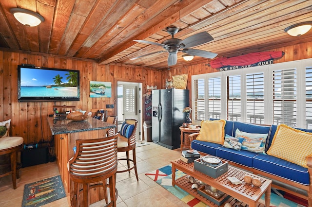 392 Carrs Point Ln, Moneta, VA 24121 - living room with wood ceiling, light tile patterned floors, wooden walls, and a ceiling fan