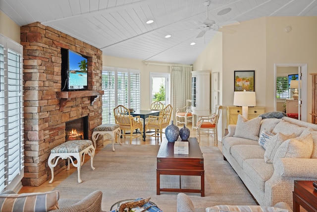 392 Carrs Point Ln, Moneta, VA 24121 - living room featuring vaulted ceiling, a stone fireplace, wood finished floors, a ceiling fan, and recessed lighting