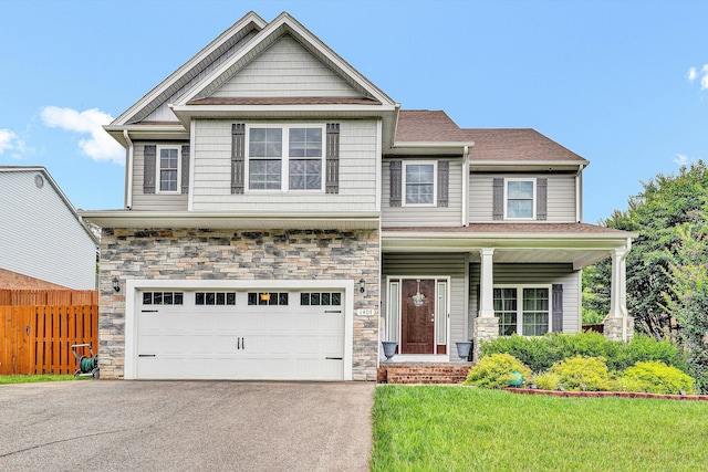 1407 Brandon Ave SW, Roanoke, VA 24015 - craftsman-style house featuring driveway, an attached garage, stone siding, and a porch