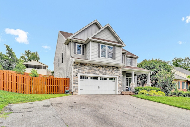 1407 Brandon Ave SW, Roanoke, VA 24015 - craftsman-style home with stone siding, asphalt driveway, a porch, an attached garage, and board and batten siding