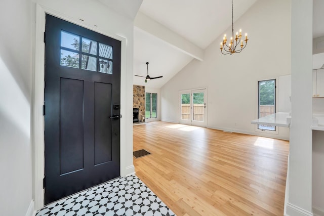 6695 Raintree Rd, Roanoke, VA 24018 - entrance foyer featuring high vaulted ceiling, light wood-type flooring, a chandelier, beamed ceiling, and a stone fireplace
