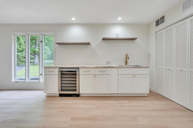 6695 Raintree Rd, Roanoke, VA 24018 - indoor wet bar with beverage cooler, light wood-type flooring, plenty of natural light, and recessed lighting