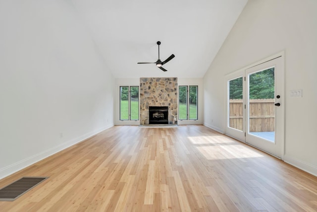 6695 Raintree Rd, Roanoke, VA 24018 - unfurnished living room with high vaulted ceiling, a ceiling fan, healthy amount of natural light, light wood-type flooring, and a stone fireplace