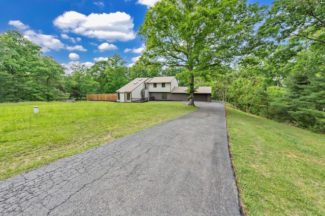 6695 Raintree Rd, Roanoke, VA 24018 - view of front of home featuring a front yard, a forest view, and asphalt driveway