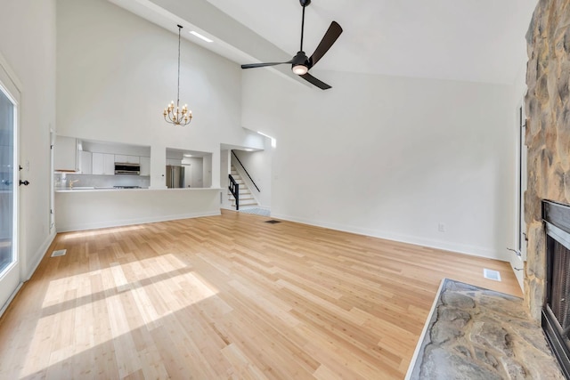 6695 Raintree Rd, Roanoke, VA 24018 - unfurnished living room with a fireplace, high vaulted ceiling, light wood-type flooring, stairway, and ceiling fan