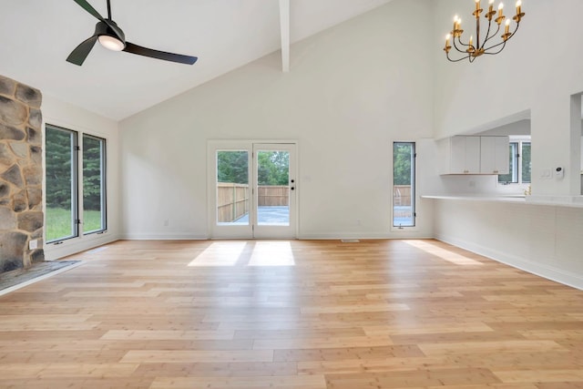 6695 Raintree Rd, Roanoke, VA 24018 - unfurnished living room featuring high vaulted ceiling, a chandelier, light wood-style floors, a ceiling fan, and baseboards