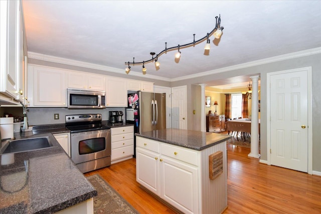7635 Peebles Ln, Roanoke, VA 24018 - kitchen featuring stainless steel appliances, ornate columns, dark countertops, white cabinets, and light wood finished floors
