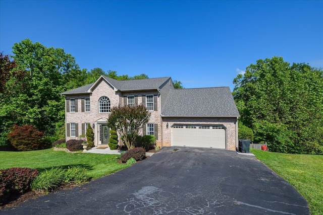 7635 Peebles Ln, Roanoke, VA 24018 - colonial-style house featuring asphalt driveway, an attached garage, brick siding, and a front yard