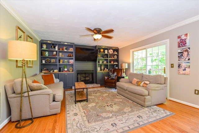 7635 Peebles Ln, Roanoke, VA 24018 - living area with wood finished floors, a fireplace, ornamental molding, ceiling fan, and baseboards