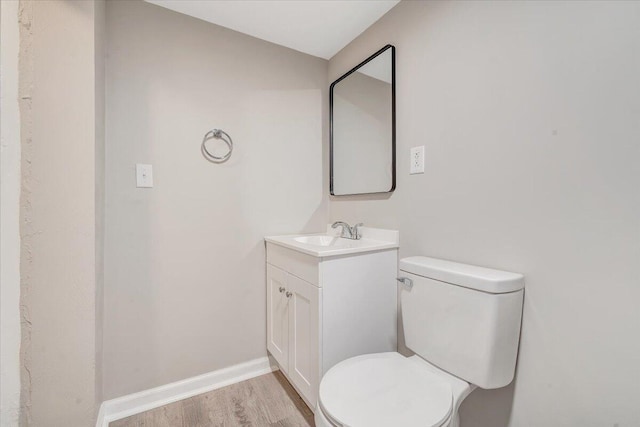 1120 6th St SE, Roanoke, VA 24013 - half bath with vanity, wood finished floors, toilet, and baseboards