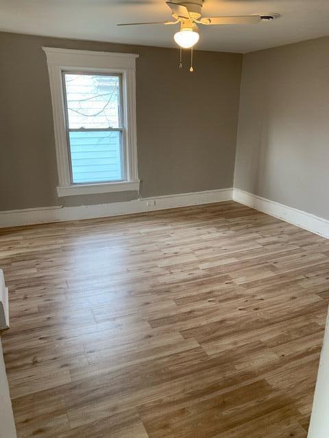 1120 6th St SE, Roanoke, VA 24013 - unfurnished room with baseboards, light wood-style floors, and a ceiling fan