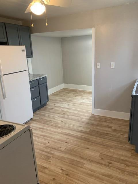 1120 6th St SE, Roanoke, VA 24013 - kitchen with freestanding refrigerator, baseboards, a ceiling fan, electric range oven, and light wood-style flooring