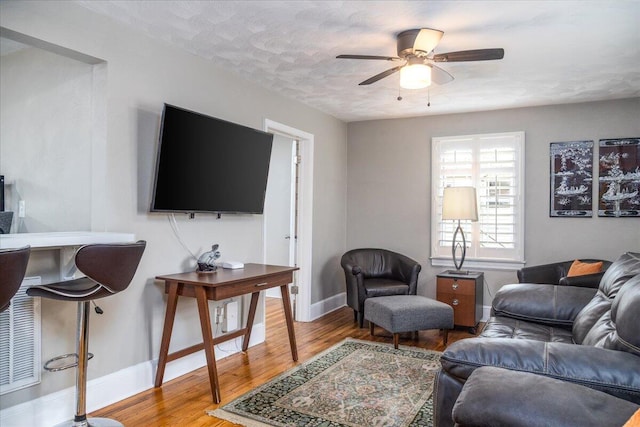 5038 Morwanda St NW, Roanoke, VA 24017 - living room featuring light wood finished floors, a ceiling fan, and baseboards